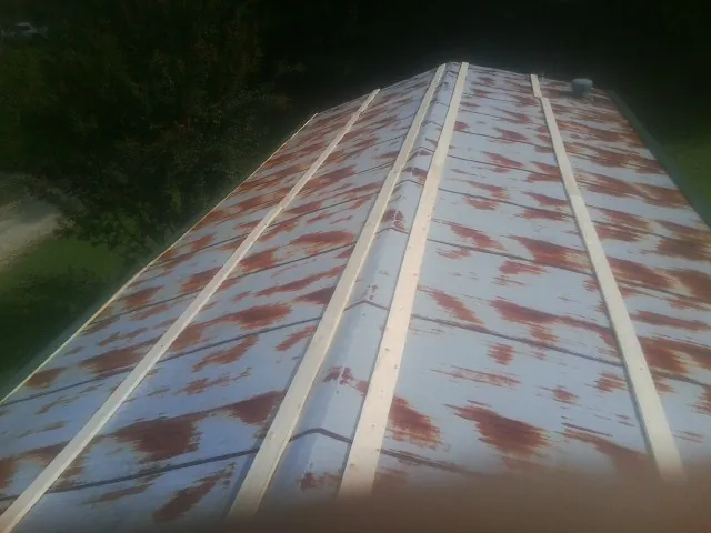Rusted metal roof panels with new wood purlins before replacement — Storm Damage Roof Repair in West Hollywood by Roofing Brothers